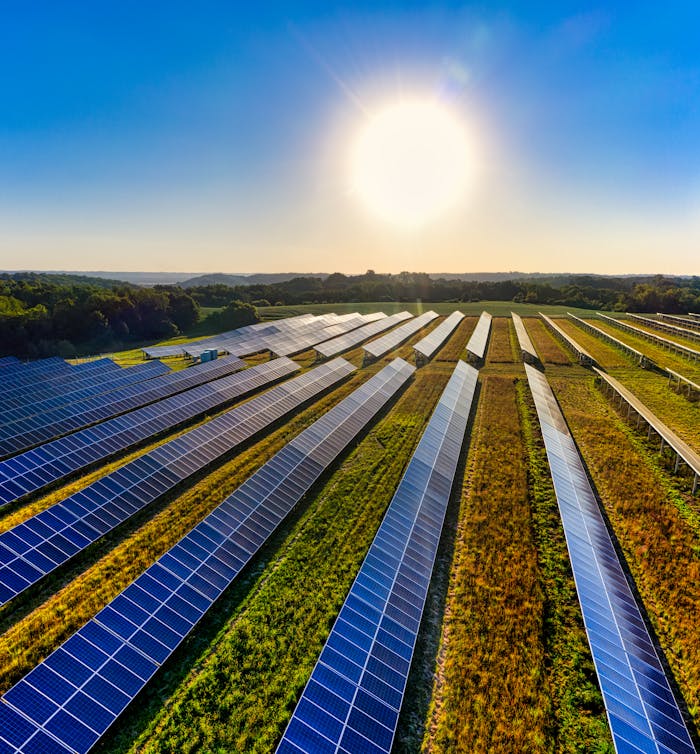gallery-3 Aerial view of a solar farm in Red Wing, MN, with solar panels harnessing the sun's energy.